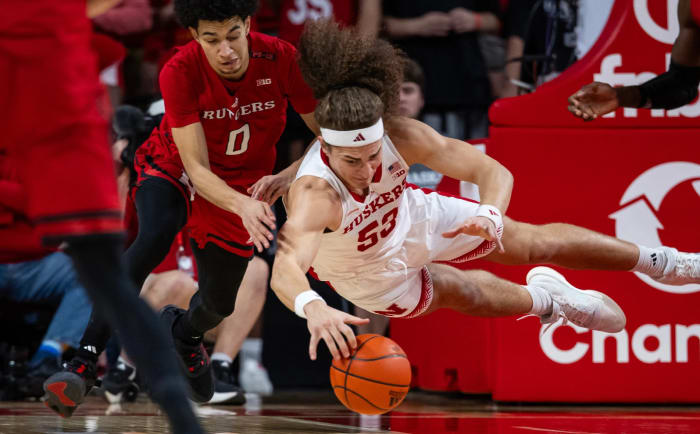 Nebraska's Josiah Allick dives for a loose ball against Rutgers' Derek Simpson on March 3, 2024, on Senior Day in Lincoln.